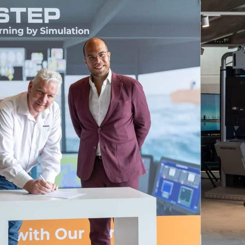 Signing ceremony in front of a NAUTIS simulator setup at VSTEP