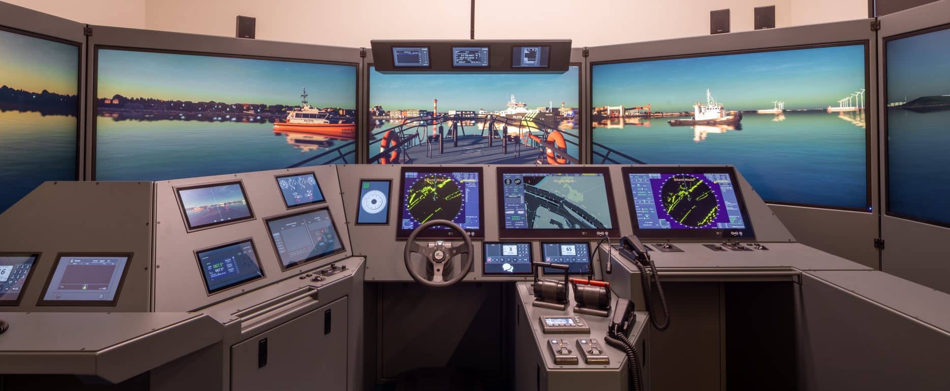 NAUTIS bridge simulator with panoramic visuals, radar and ECDIS displays during a harbour approach