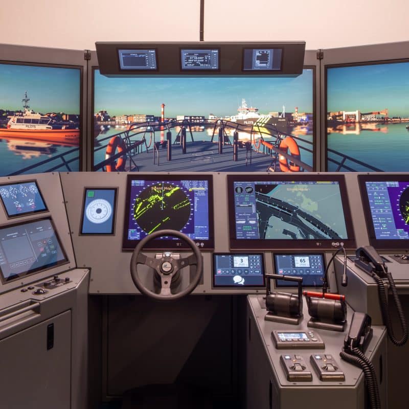 NAUTIS bridge simulator with panoramic visuals, radar and ECDIS displays during a harbour approach